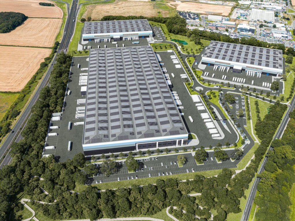 Aerial view of a modern industrial warehouse complex with solar panels, loading bays, parking areas, roads, and landscaped surroundings